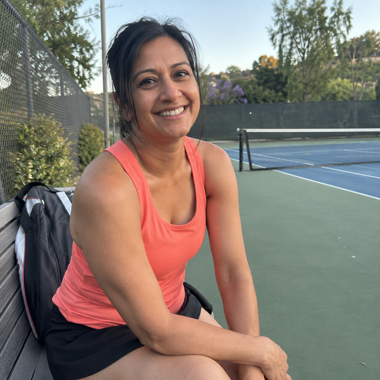 Priya Shah beside a tennis court